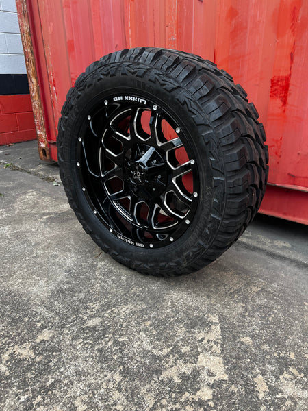 20x10 6x5.5 & 6x135 Luxx Hd LHD13 Gloss Black Milled wheels and 33x12.50 Red Dirt Road MT tires